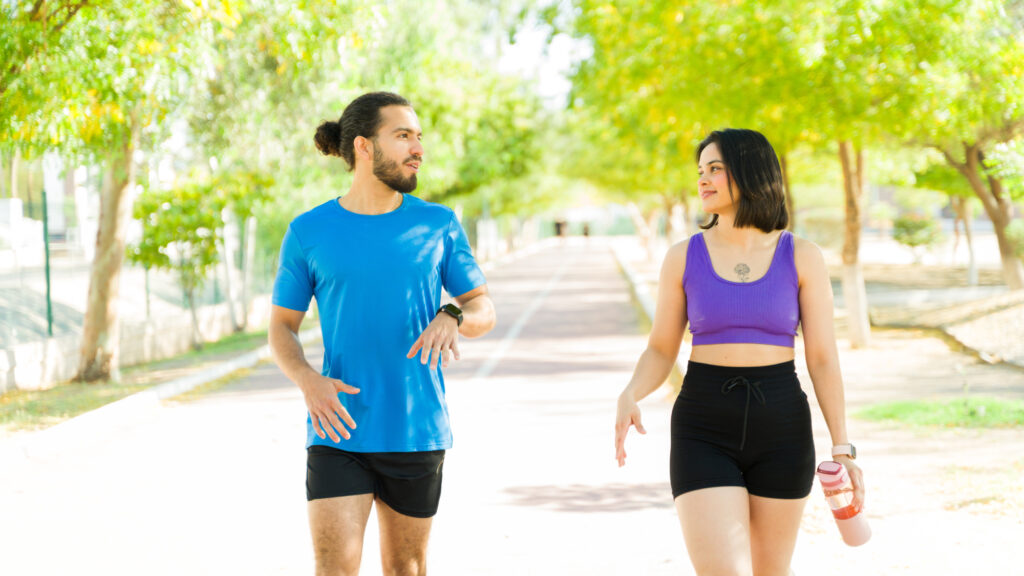 couple of runners talking after workout session in park