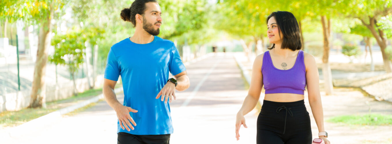 couple of runners talking after workout session in park