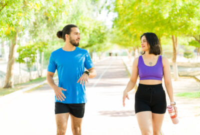 couple of runners talking after workout session in park