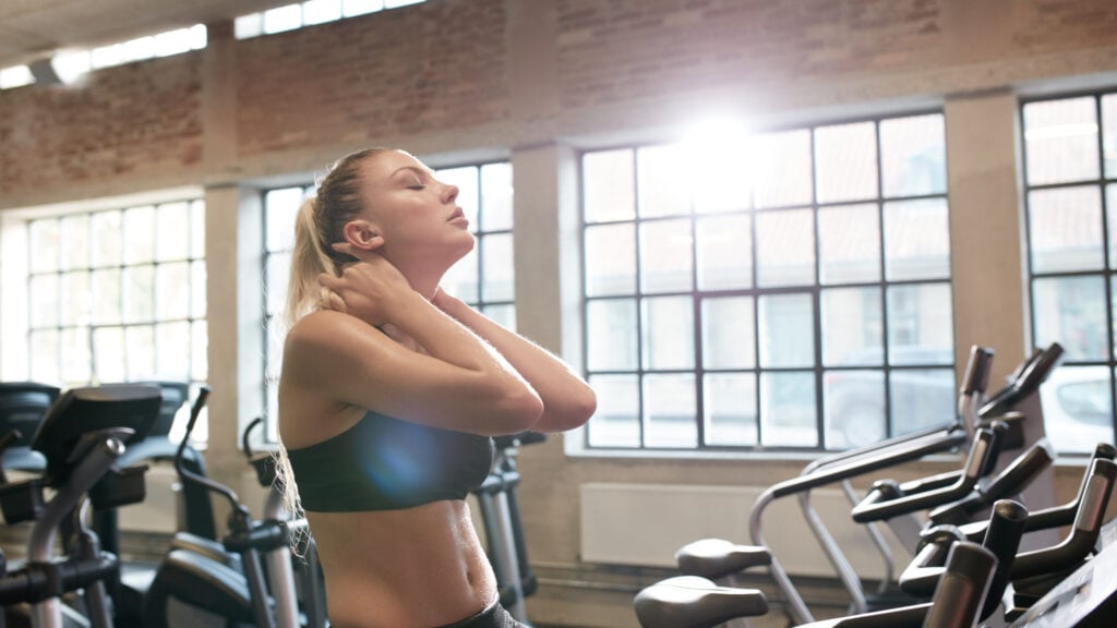 woman tired after intense workout on gym bike