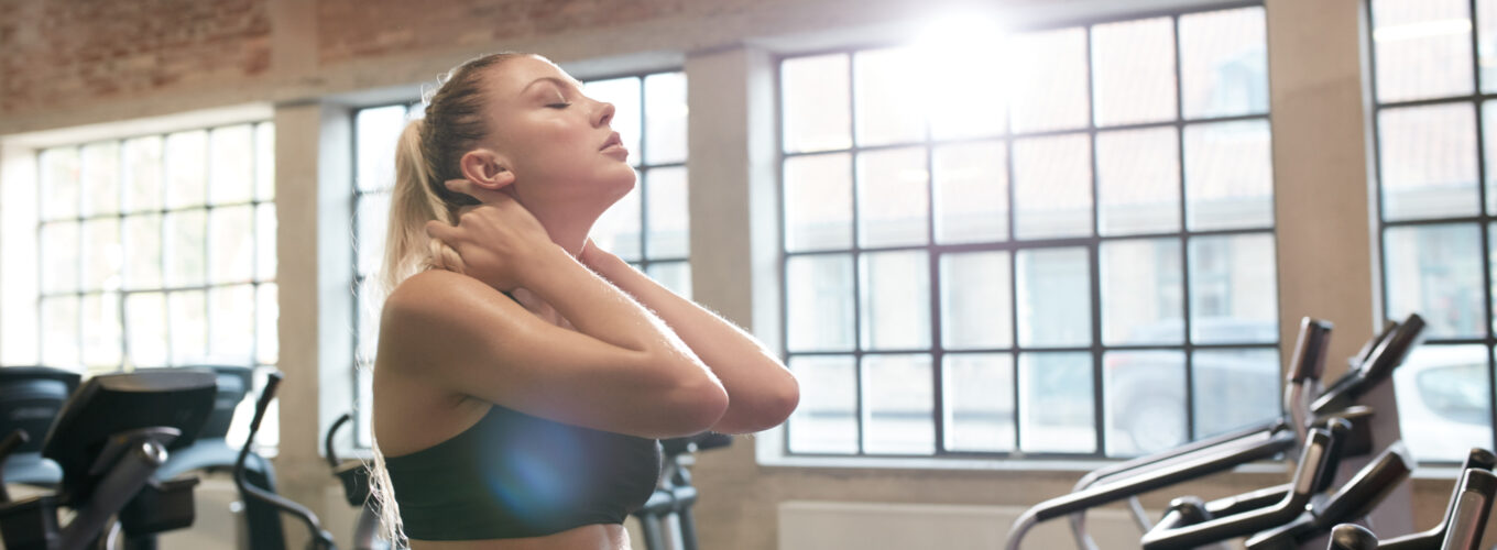 woman tired after intense workout on gym bike
