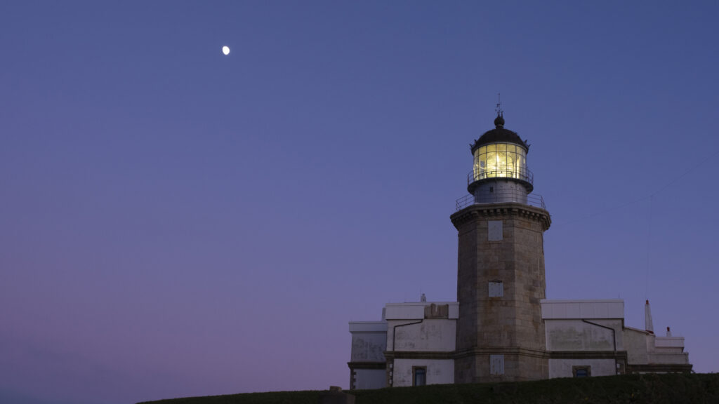 the moon over the lighthouse of matxitxako, bizkaia