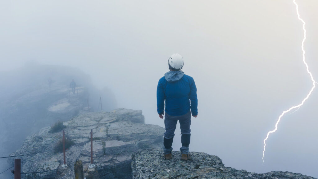 hiker watching lightning strike on the summit of cofre de perote volcano