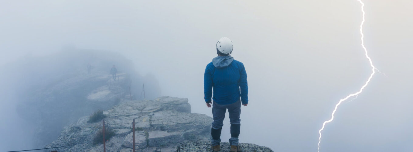 hiker watching lightning strike on the summit of cofre de perote volcano